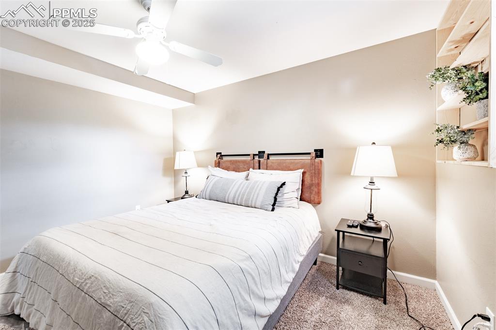 Image 32 of 39: Carpeted bedroom with baseboards and a ceiling fan