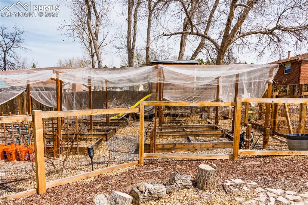 Image 8 of 39: View of yard featuring a garden and an outdoor structure