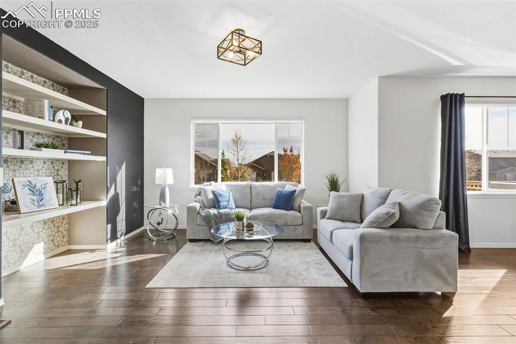 Image 18 of 41: Living area featuring wood-type flooring