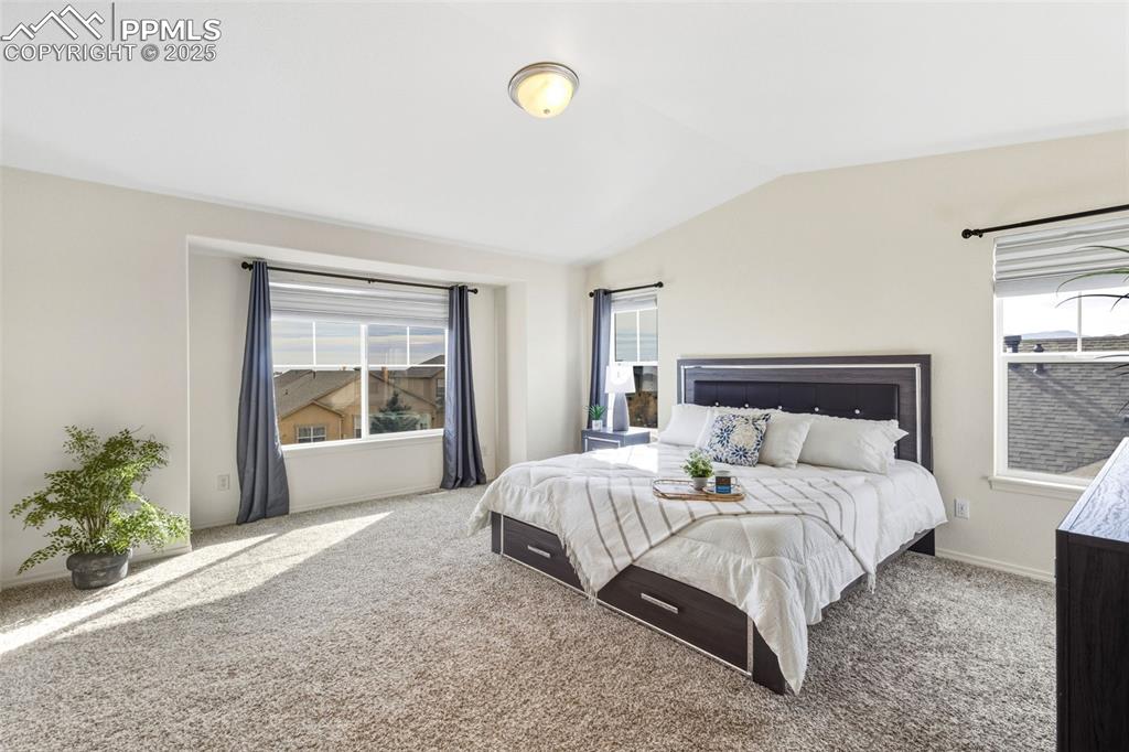 Image 21 of 41: Bedroom featuring carpet and lofted ceiling