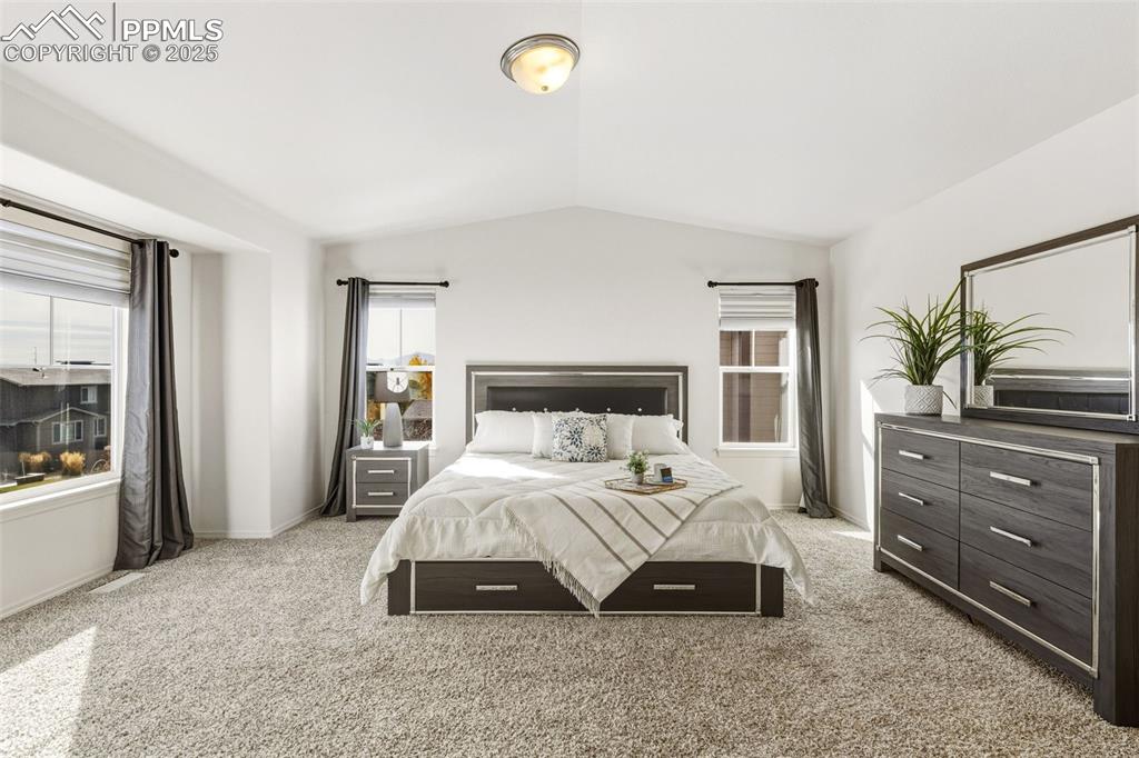 Image 22 of 41: Bedroom featuring light colored carpet and lofted ceiling