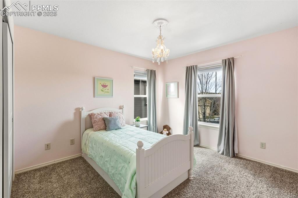 Image 25 of 41: Bedroom featuring carpet flooring and a chandelier