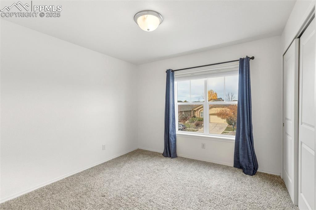 Image 26 of 41: Spare room with light carpet and baseboards