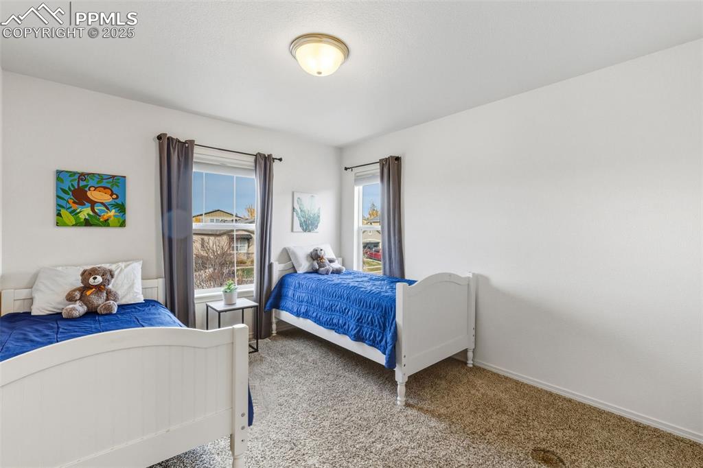 Image 27 of 41: Bedroom with carpet floors and baseboards
