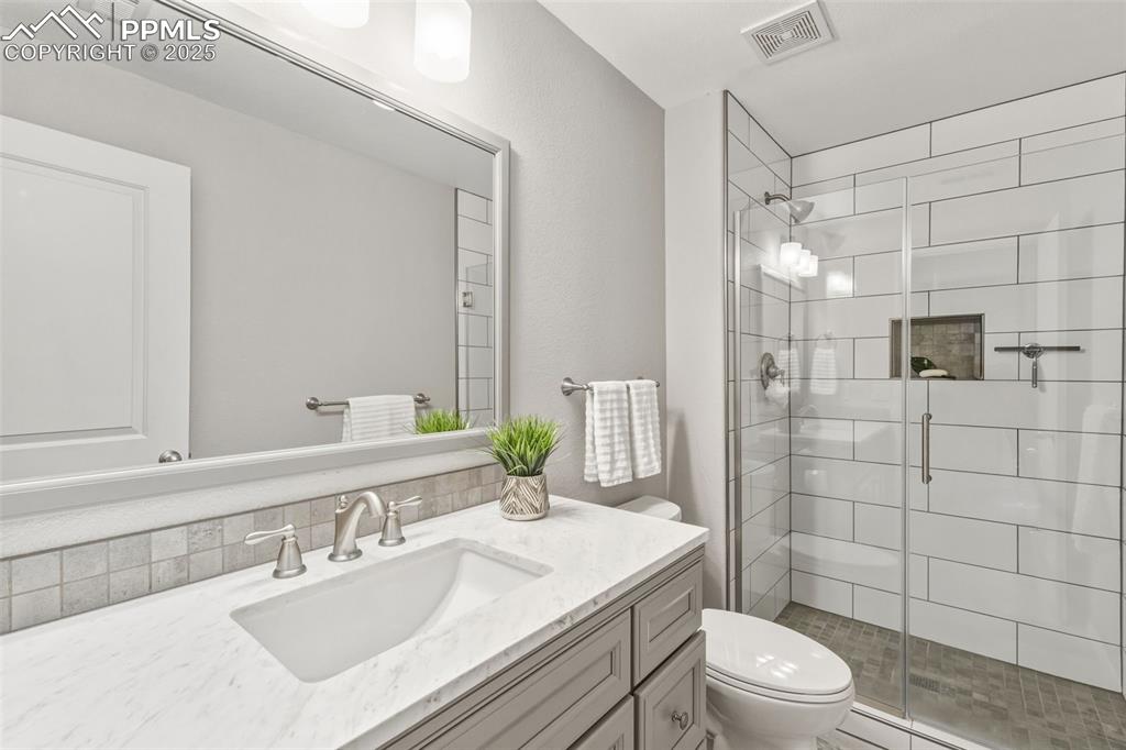 Image 32 of 41: Full bathroom featuring vanity and a stall shower