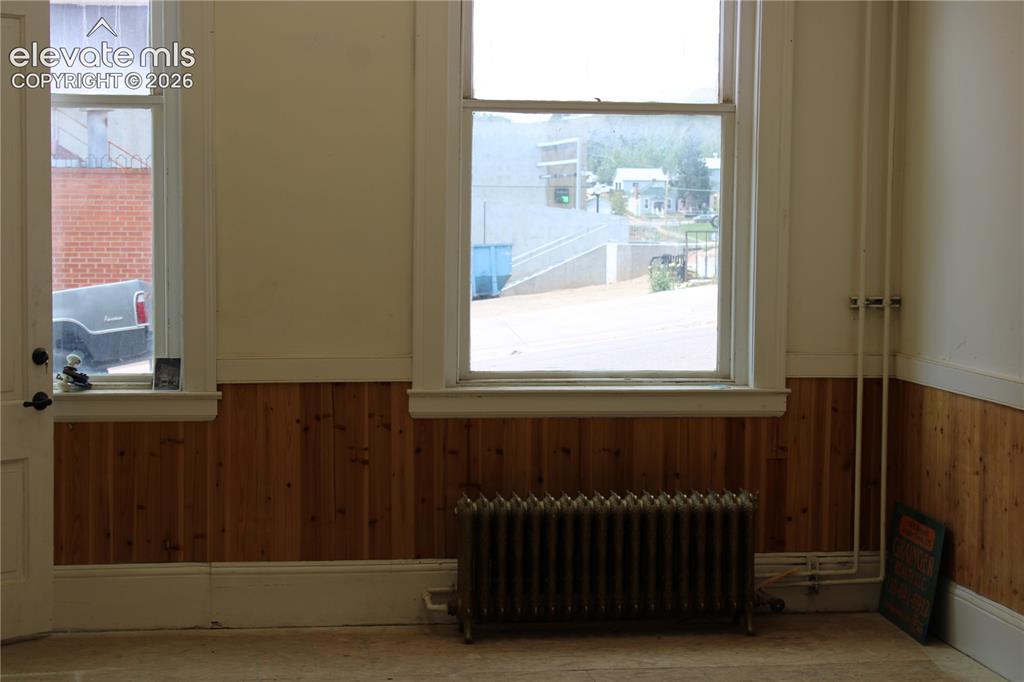 Image 4 of 11: looking west out a window in a finished retail space on the main level. 