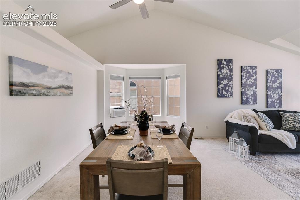 Image 10 of 47: Vaulted ceiling with ceiling fan, bay window, and a built-in wall niche