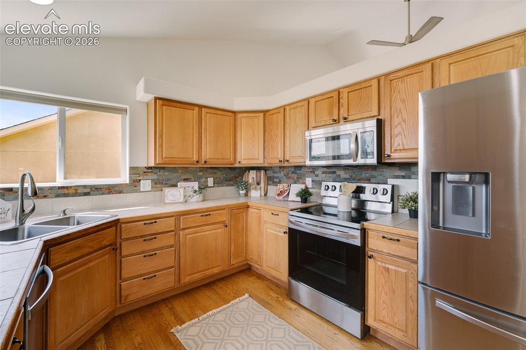 Image 12 of 47: Kitchen featuring wood-finish cabinetry, stainless steel appliances, a mult