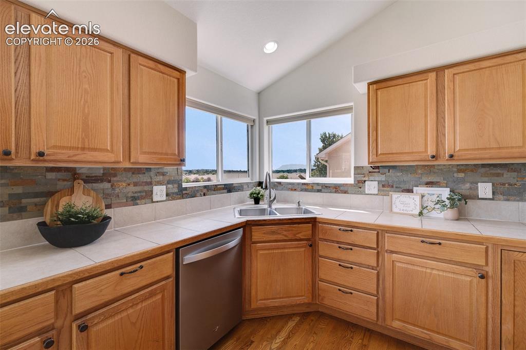 Image 13 of 47: Kitchen featuring wood cabinetry, integrated stainless steel dishwasher, du