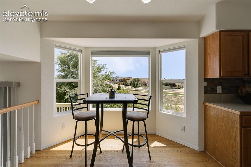Image 14 of 47: Bay window with three distinct panels, wood-finish flooring, recessed light