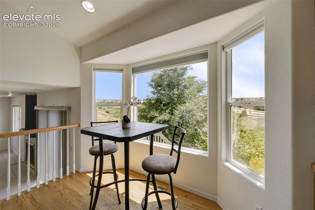 Image 15 of 47: Bay window featuring multiple large panes, hardwood flooring, and a recesse