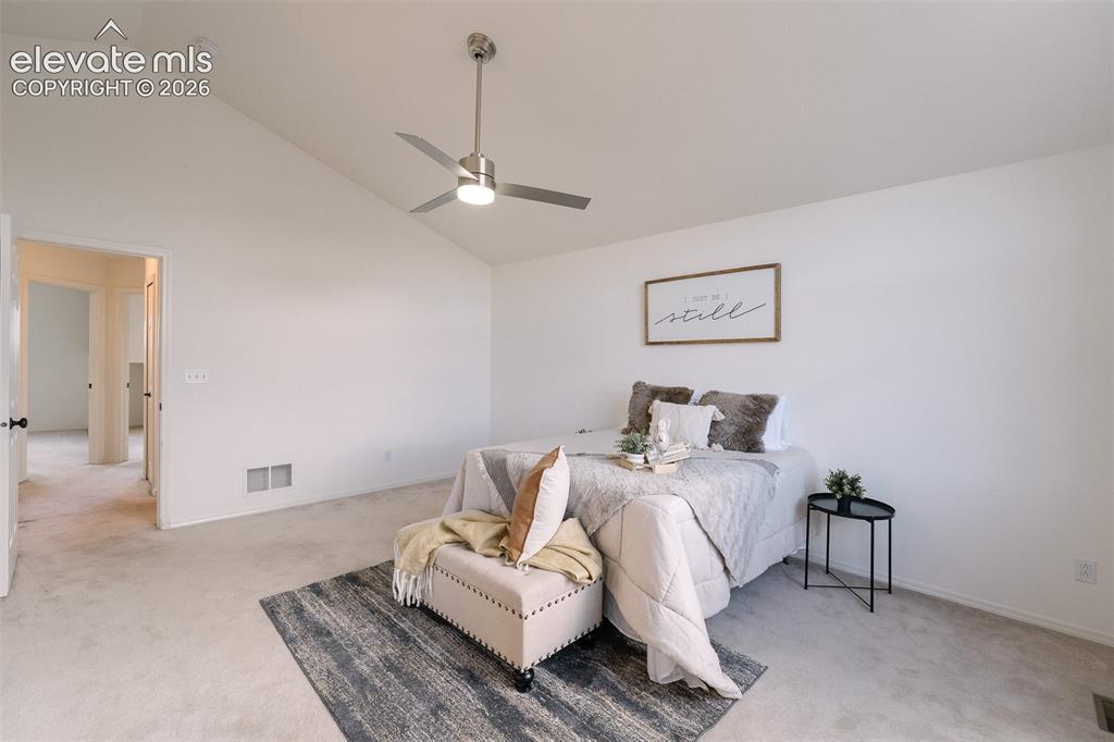 Image 19 of 47: Vaulted ceiling with contemporary ceiling fan, light-colored carpeting, and