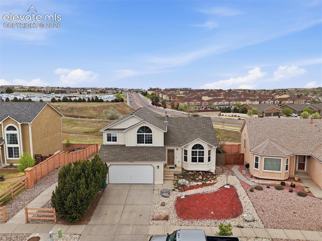 Image 2 of 47: Two-story residence with an attached two-car garage, bay windows, and a lan
