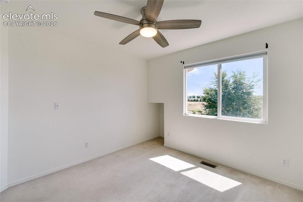 Image 29 of 47: Recessed window, ceiling fan with integrated lighting, and neutral carpetin