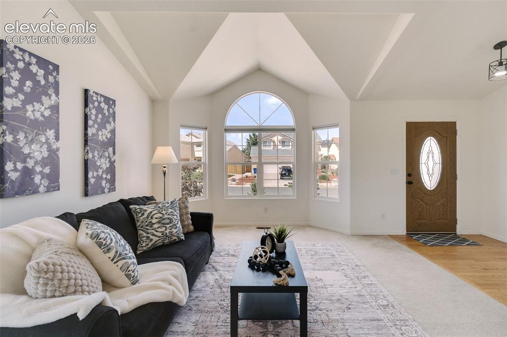 Image 3 of 47: Vaulted ceilings, arched window with divided lites, multiple windows, front