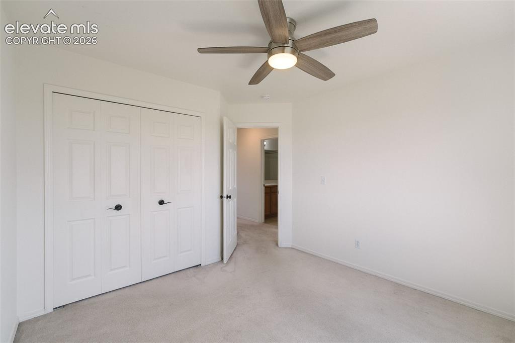 Image 32 of 47: Ceiling fan with light fixture, light-colored carpet flooring, white panele