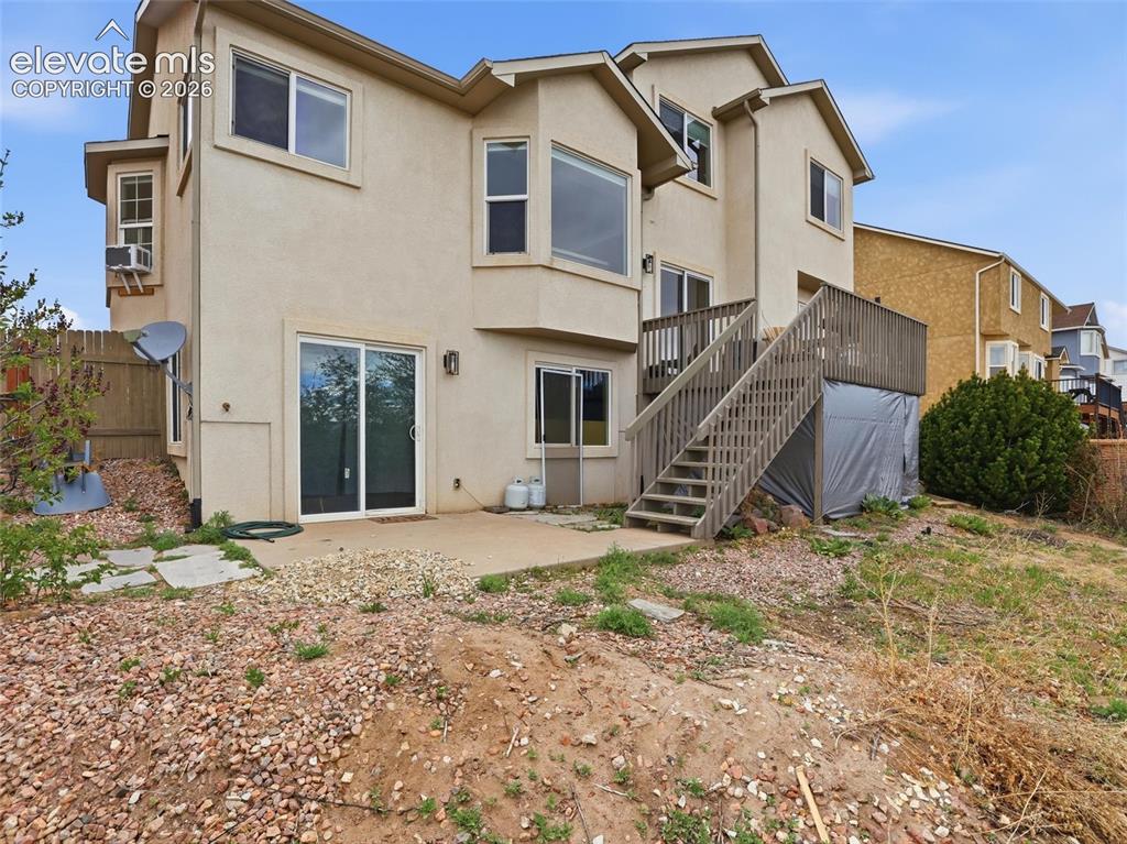 Image 44 of 47: Multi-level stucco exterior with multiple window configurations
