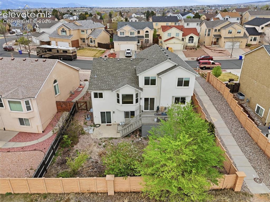 Image 45 of 47: Two-story residence featuring a private backyard, an upper-level deck, and
