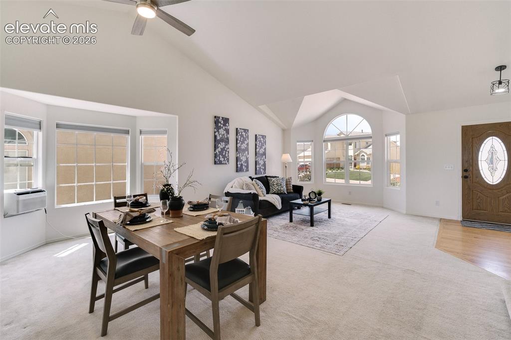 Image 9 of 47: Vaulted ceilings, a decorative arched window, and a paneled entry door with