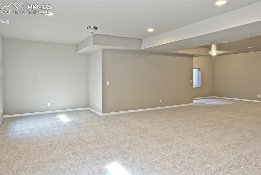 Image 22 of 25: Empty room featuring carpet floors and recessed lighting