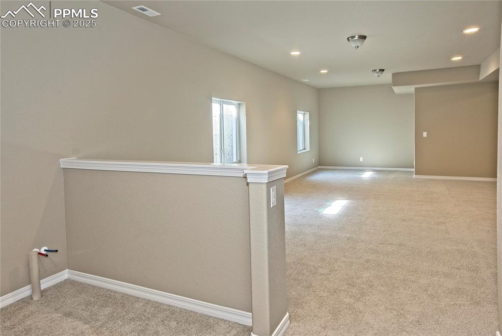 Image 23 of 25: Spare room featuring light carpet and recessed lighting