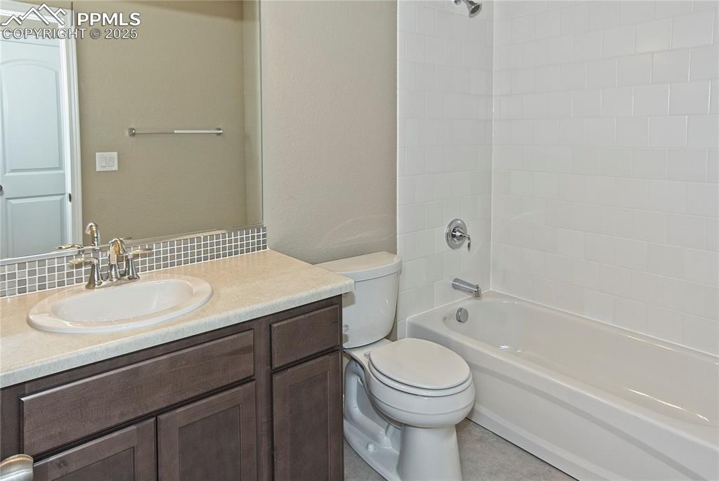 Image 24 of 25: Bathroom featuring vanity and bathing tub / shower combination