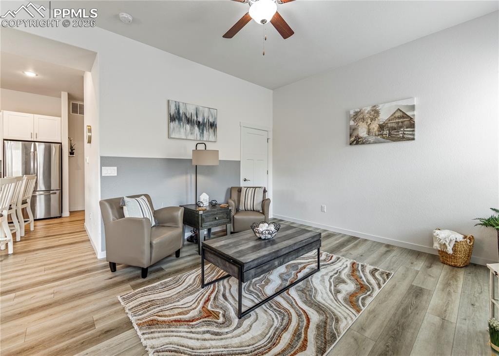 Image 18 of 46: Living room featuring a ceiling fan and light wood finished floors