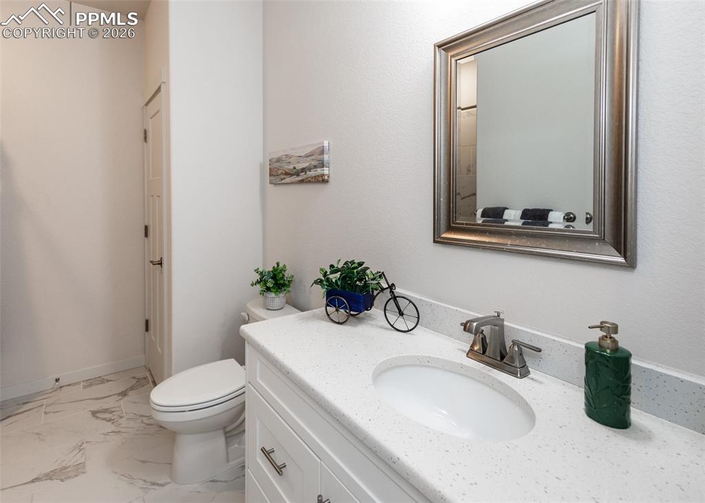 Image 37 of 46: Bathroom featuring vanity and light marble finish flooring