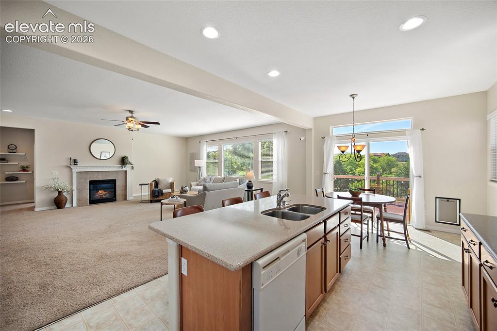 Image 13 of 40: Kitchen, Living Room & Sliding Glass Door to Deck