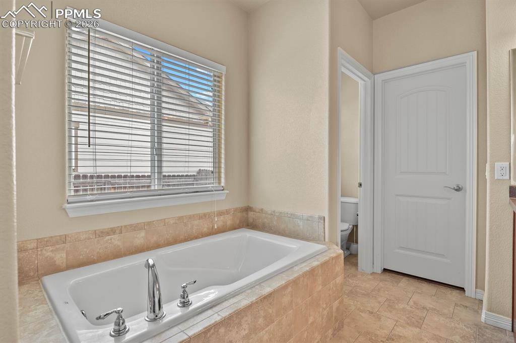 Image 19 of 45: Main level bedroom attached bathroom tub