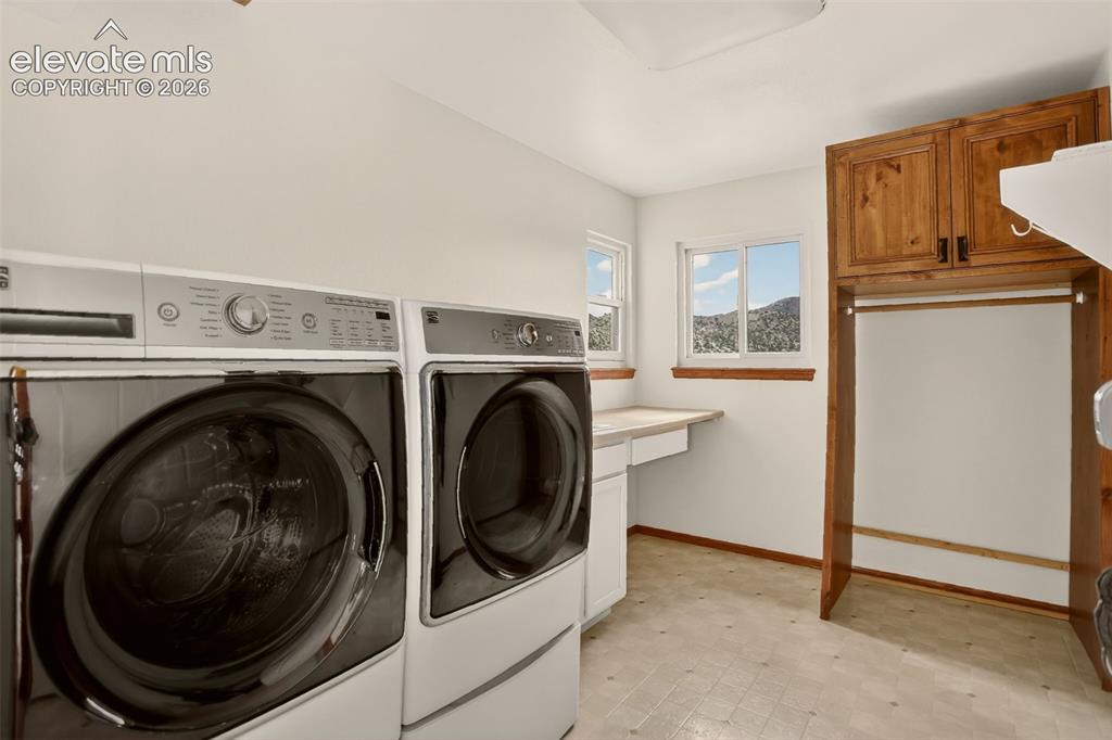 Image 21 of 50: Laundry room on main level with laundry shoot, utility sink and double wash