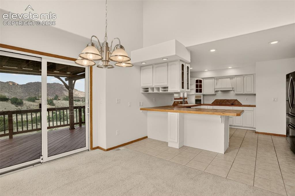 Image 25 of 50: From the 2nd dining room. Through kitchen to the right is the family room