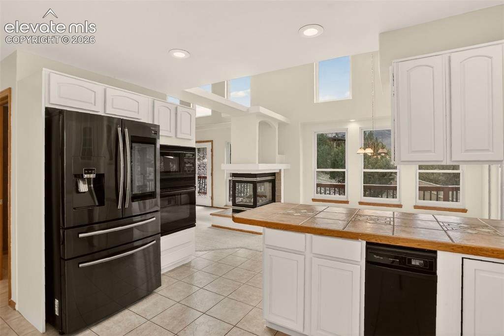 Image 27 of 50: Kitchen (hall to left of fridge to powder room, panty closets, formal dinin