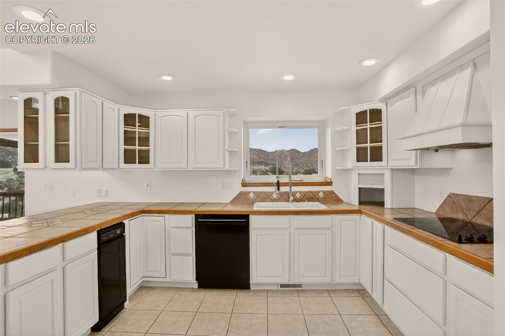 Image 28 of 50: Kitchen (standing at entryway to family room, formal dining room and powder