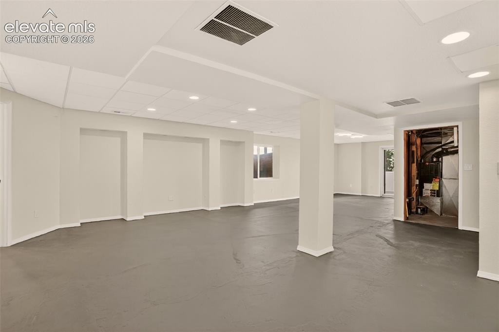 Image 44 of 50: Recreation/Family room (basement). Utility room ahead. To the right of that