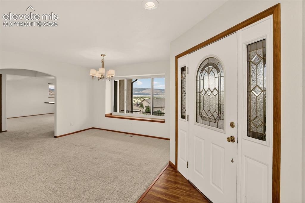 Image 8 of 50: Entryway with formal dining room