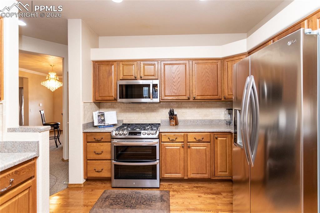 Image 18 of 50: Another view of the kitchen; note the decorative ledges above the cabinets!