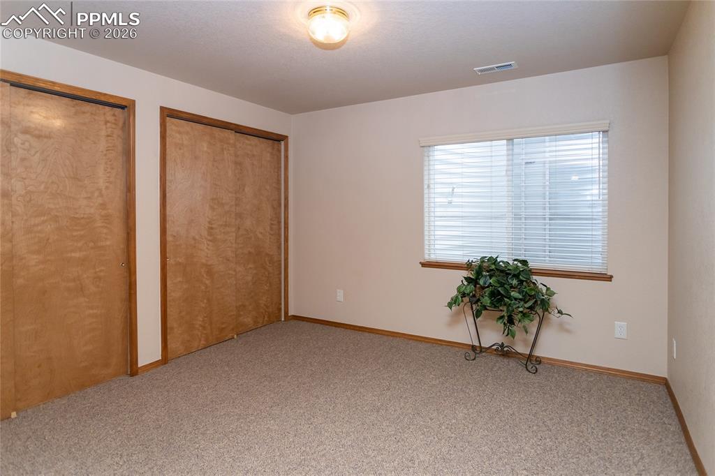 Image 38 of 50: Bedroom #4 in the basement features double closets.