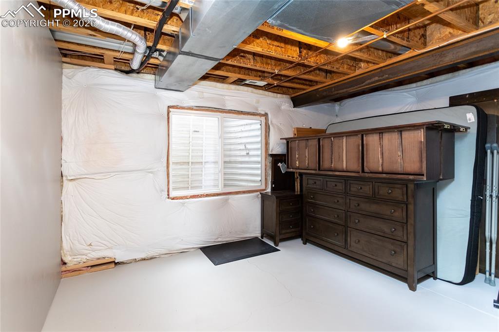 Image 41 of 50: Unfinished 5th bedroom in the basement is currently used as storage.