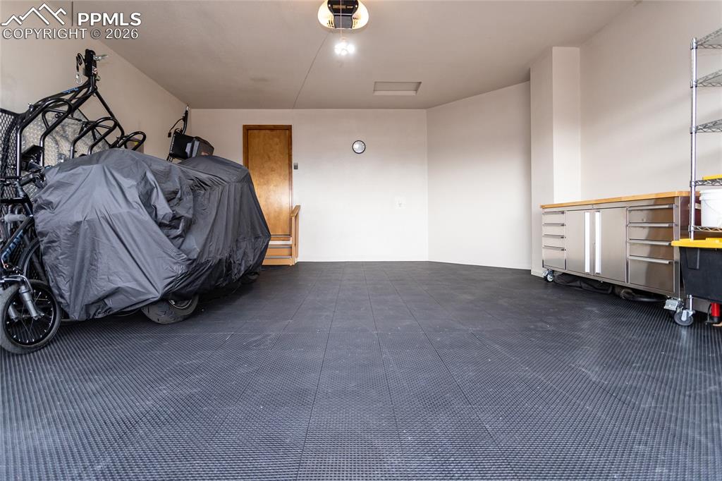 Image 44 of 50: Garage features modular MotoFloor self drainage floor tiles!