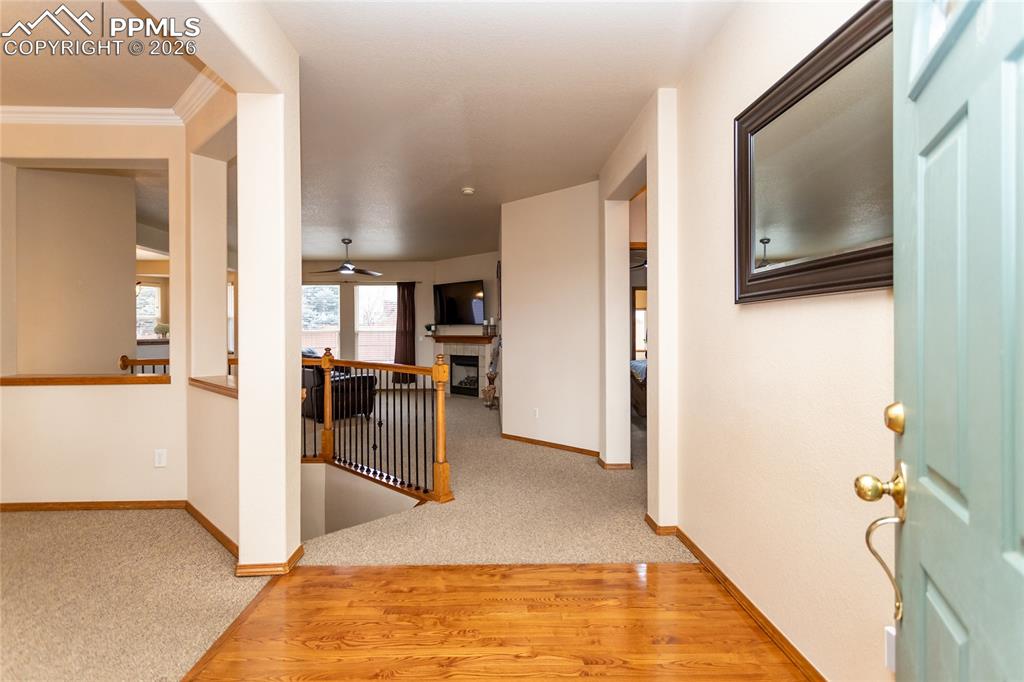 Image 7 of 50: Large foyer with hardwood flooring.