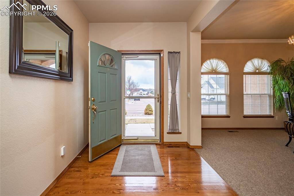 Image 8 of 50: Another view of the foyer featuring storm door.