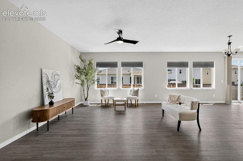 Image 10 of 47: Spacious interior featuring dark wood-finish flooring, light neutral-toned