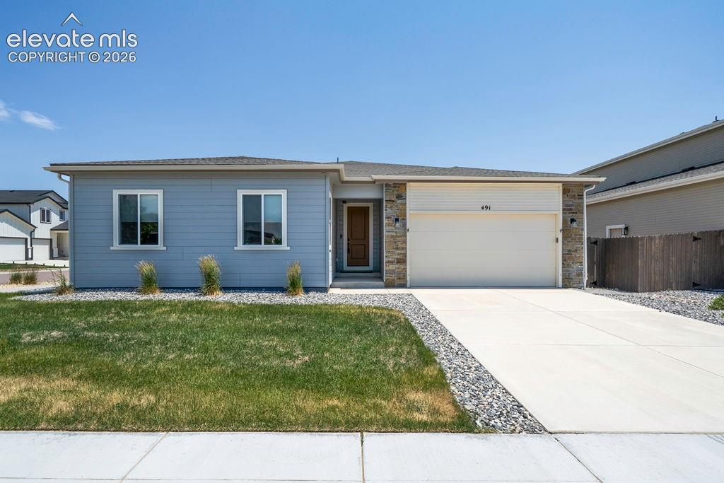 Image 2 of 47: Contemporary single-story residence featuring light blue siding with stone