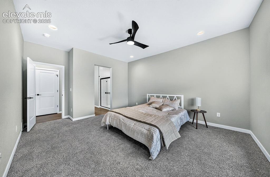 Image 25 of 47: Spacious room featuring neutral carpeting, light gray walls, a modern black