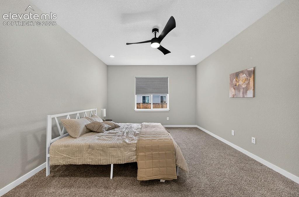 Image 26 of 47: Spacious room featuring neutral carpeting, light gray wall paint, and white