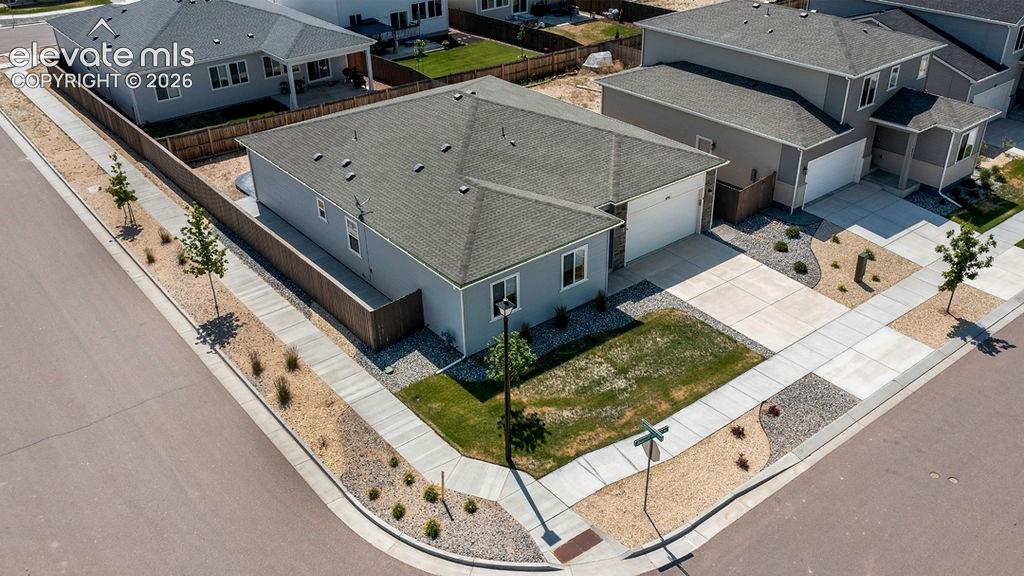 Image 3 of 47: Contemporary single-story residence featuring a two-car garage, grey siding