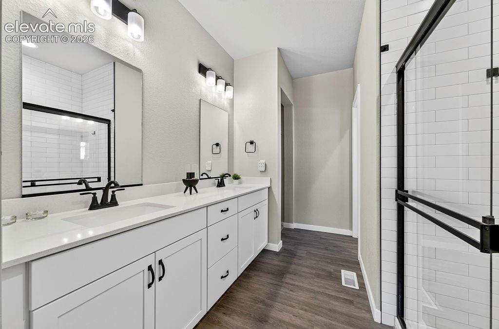 Image 31 of 47: Bathroom featuring a dual vanity with white cabinetry, white countertops, a