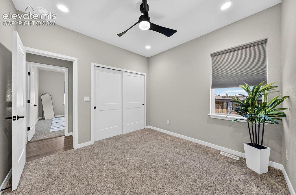 Image 34 of 47: Light gray wall paint complemented by white trim and a white two-panel slid