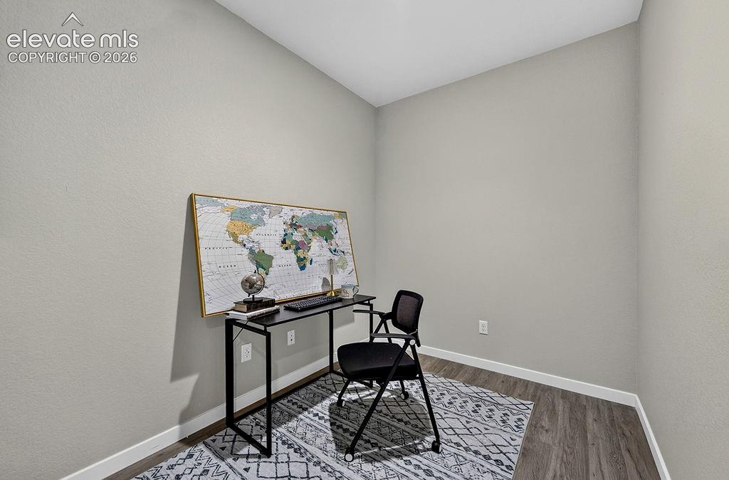 Image 43 of 47: Room featuring light gray walls, white baseboards, and wood-finish flooring